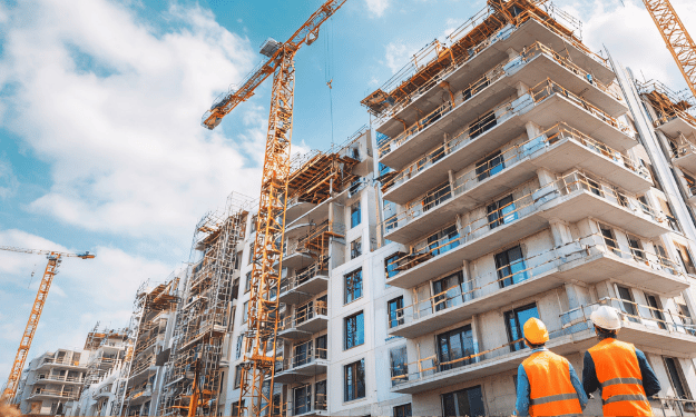 Large construction site with multiple workers/equipment